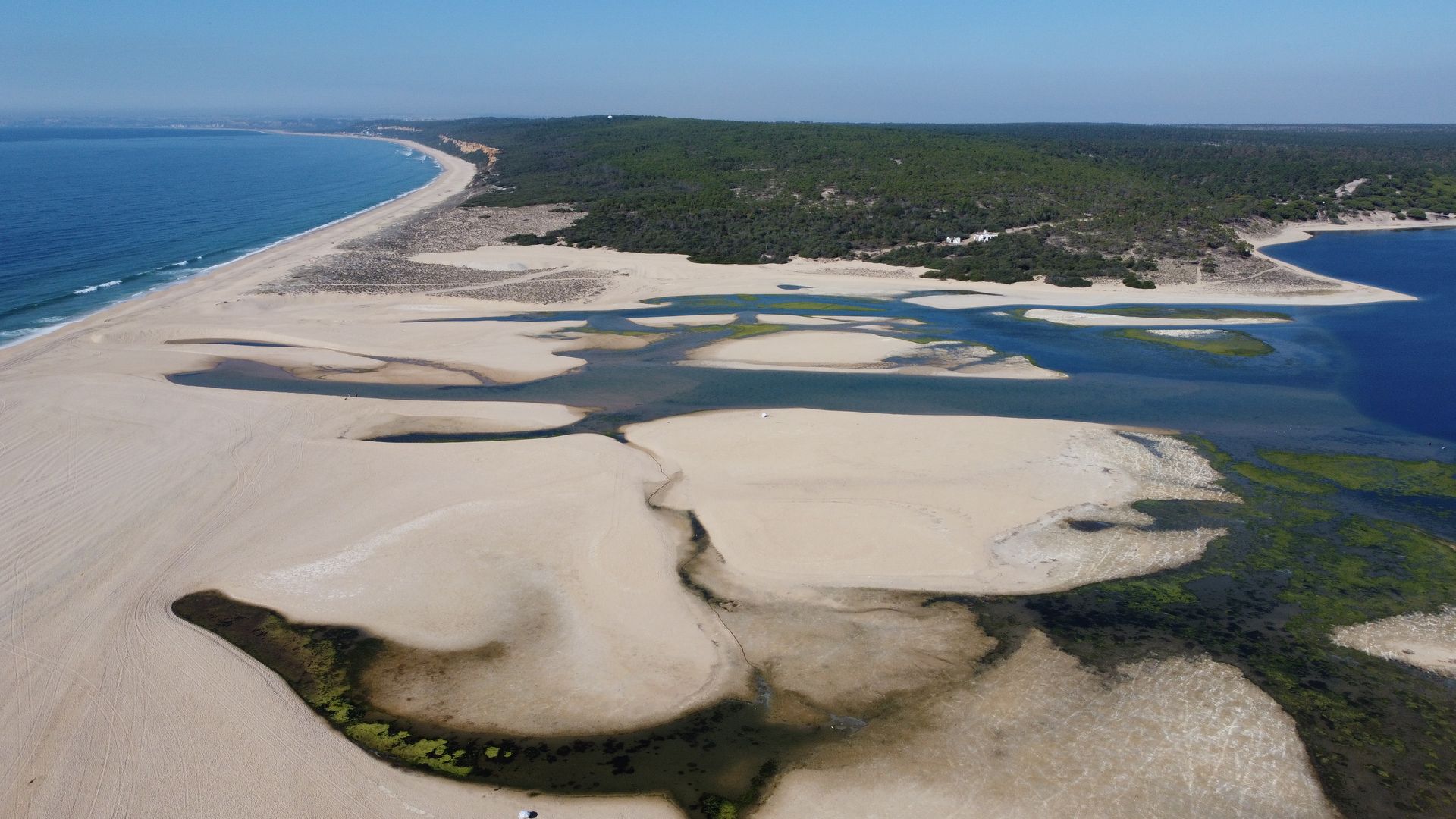 Aerial view of sandbanks and a lagoon beside the sea, taken by drone.
